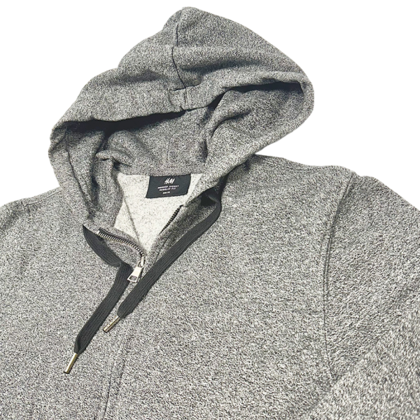 Grey H&M zip-through hoodie for women, featuring front zipper and hood, displayed flat for women's hoodies collection.