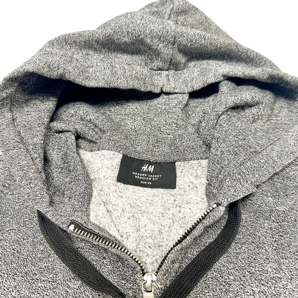 Close-up of H&M zip-through hoodie in gray, soft fabric, perfect for women's hoodies collection.