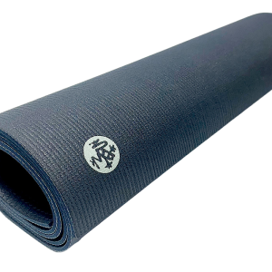 Rolled-up Manduka PROlite Yoga Mat in dark blue with logo visible on the surface.