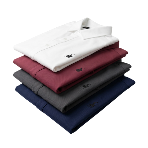 Stack of British Polo short sleeve men's fashion shirts in white, maroon, gray, and navy blue colors.