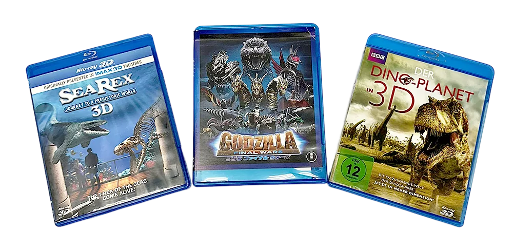 Three dinosaur-themed Blu-ray cases, including "Dinosaur Planet 3D," displayed for product sale.