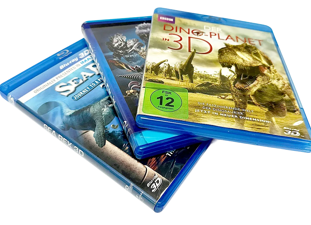 Three Blu-ray cases, with "Dino Planet in 3D" featuring dinosaurs on the cover, displayed at an angle.