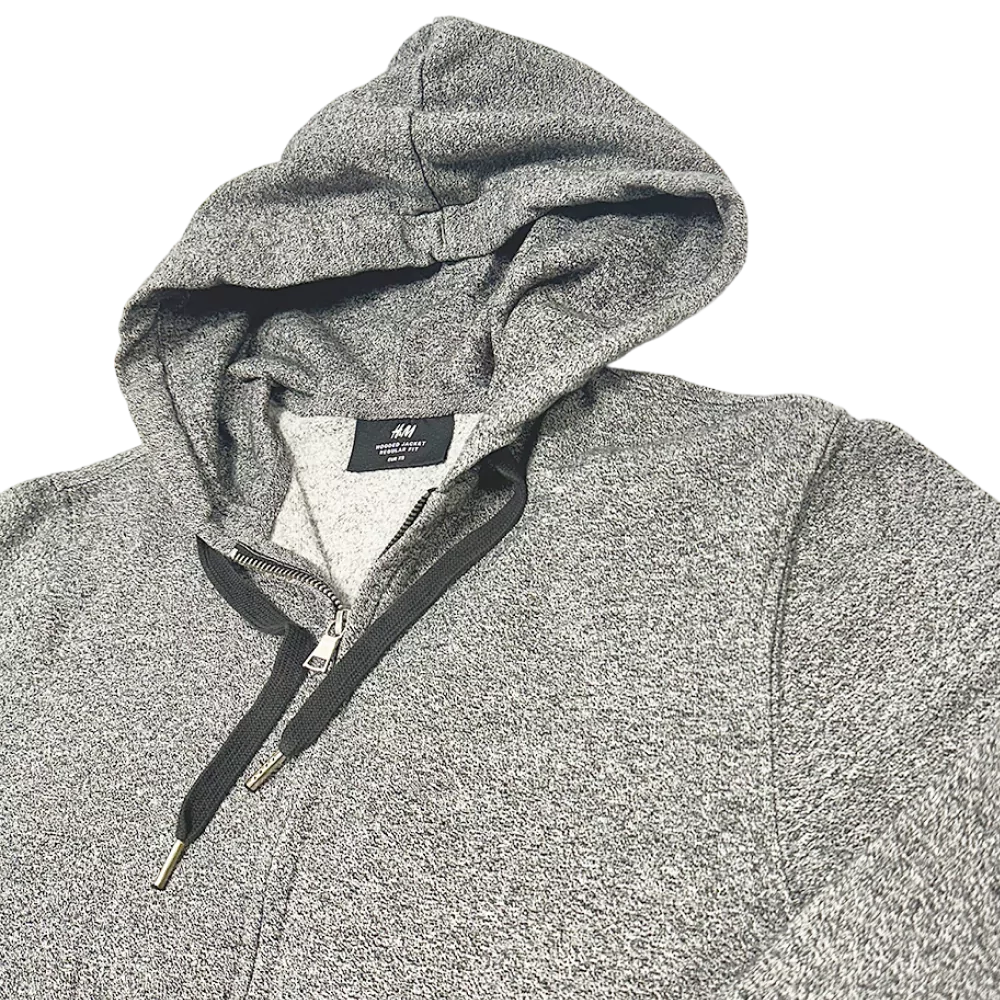 Sweat à capuche zippé gris H&M, coupe classique, cordon noir et tissu chiné.