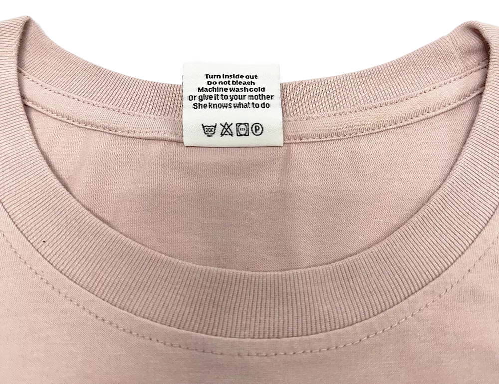 Col ras-du-cou rose clair du t-shirt FunTee Motor Atlanta avec étiquette d’entretien visible.