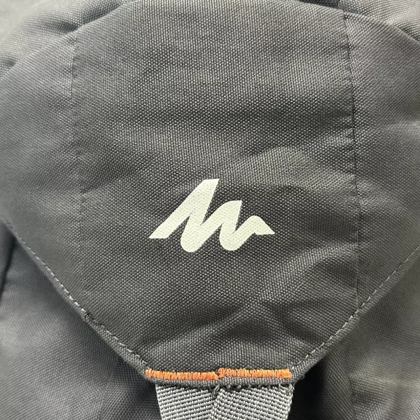 Close-up of Quechua Arpenaz Backpack in gray, featuring the white Quechua logo on the fabric.