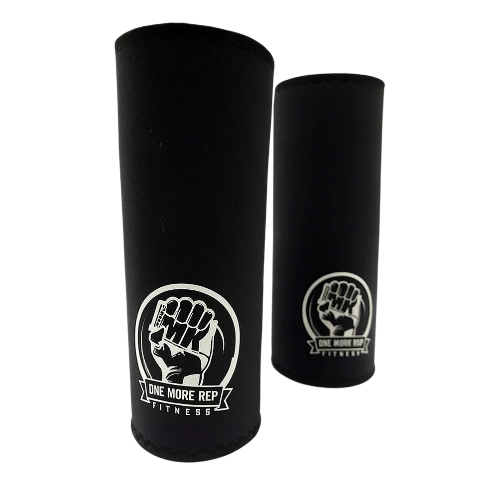 Pair of black One More Rep Fitness kneepads with white logo, designed for athletic knee support.