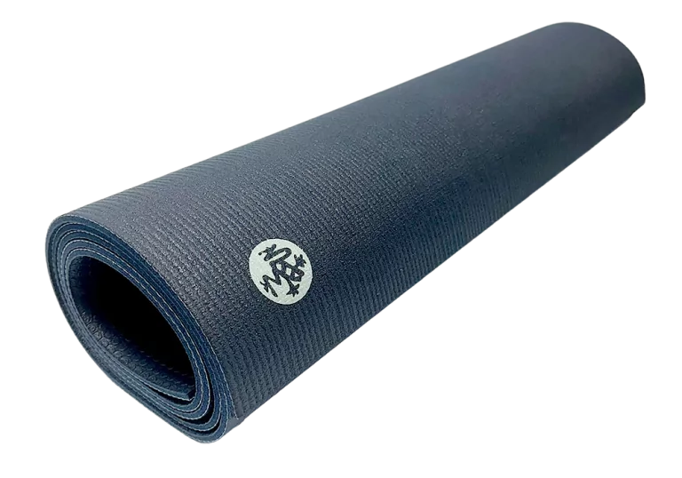 Rolled-up Manduka PROlite Yoga Mat in dark blue with logo visible on the surface.