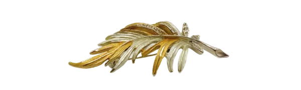 Two-tone gold leaf brooch featuring intricate, overlapping gold and silver-toned metalwork in a leaf design.