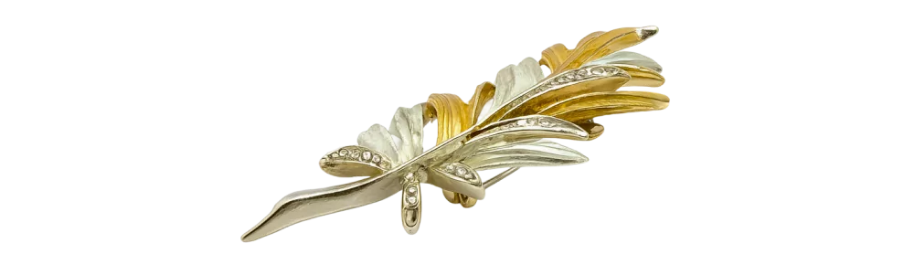 Two-tone gold leaf brooch featuring silver and gold hues with a detailed, textured design.