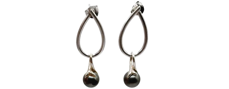 Srebrne kolczyki wiszące z ciemnymi perłami, stylowy dodatek do eleganckich stylizacji.