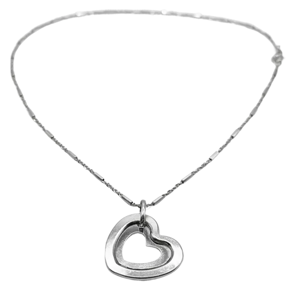 Silver heart pendant necklace with a delicate chain, featuring an open double-heart design.